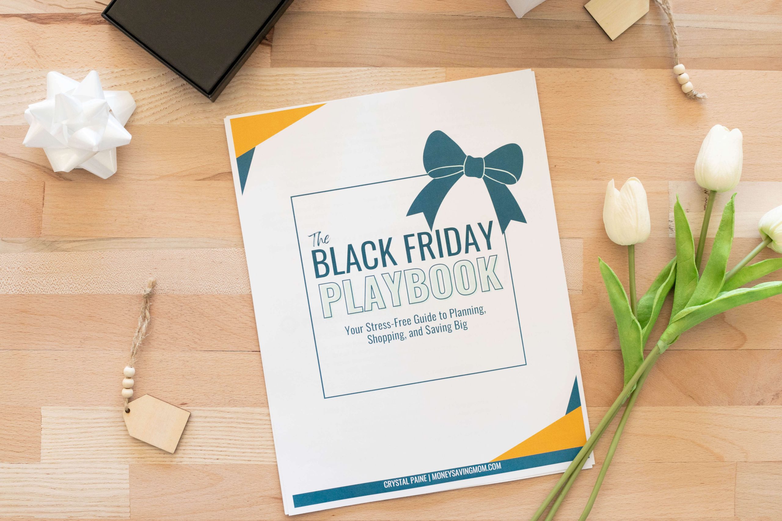 A flat lay featuring "The Black Friday Playbook" - Your Stress-Free Guide to Planning, Shopping, and Saving Big.